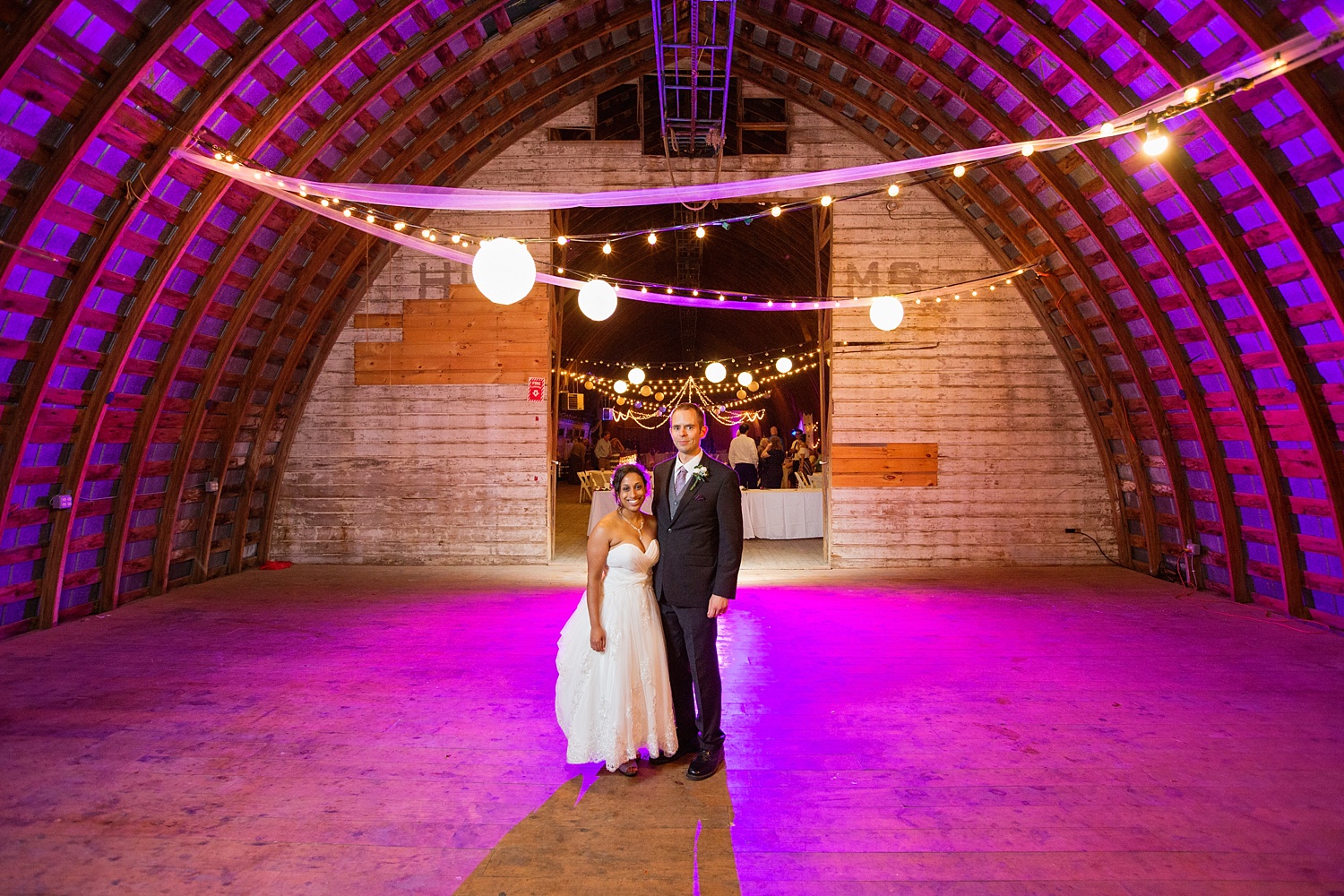 MJK Farm, barn wedding, bride and groom, twinkle lights, purple