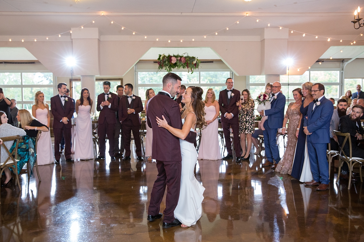 chantelle marie lakehouse and celebration venue, sarah heppell photography, whistlestop florist reception decor, mlh events reception decor, maroon, blush and greenery decor, bride and groom first dance, parents watch bride and groom first dance