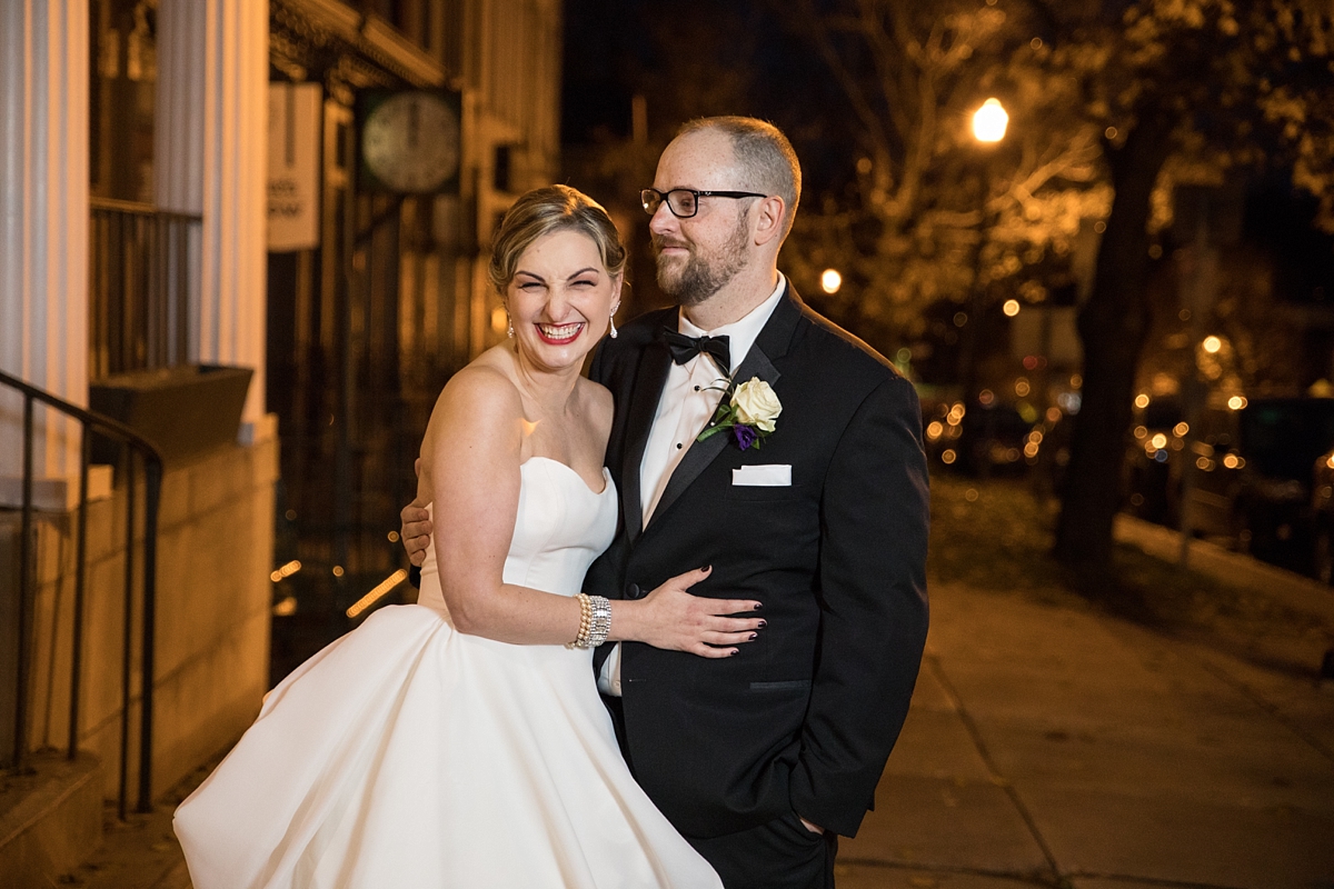 bride and groom giggle outside of the lincklaen house in cazenovia ny on their wedding day, sarah heppell photography