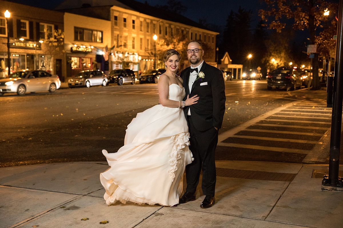 bride and groom pose outside at night at the lincklaen house in cazenovia, ny, sarah heppell photography