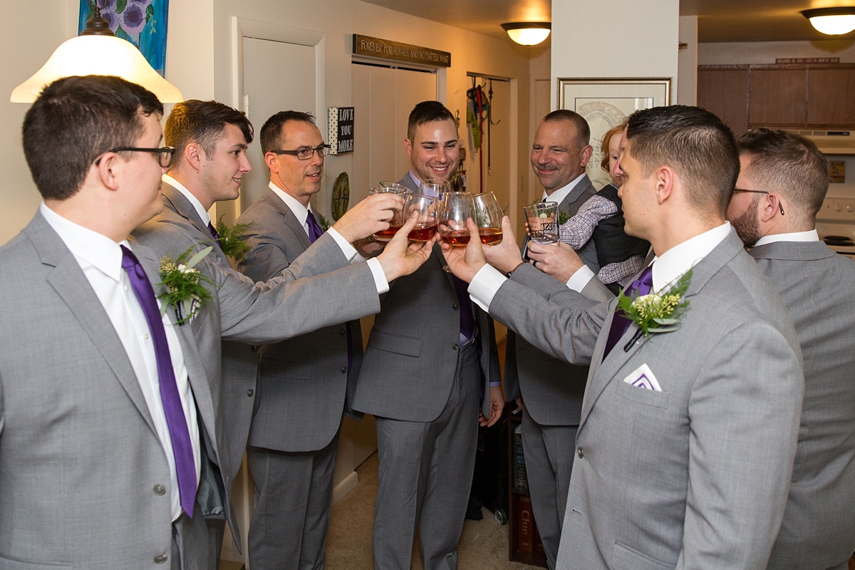 groom and groomsmen have a toast with groom's father
