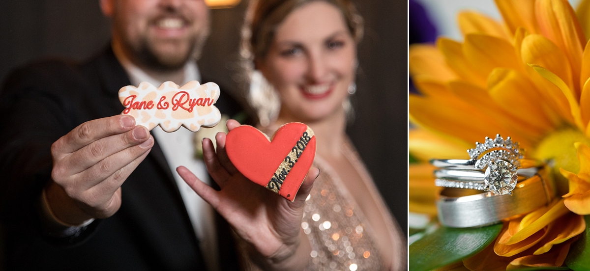 bride and groom pose with customized wedding day sugar cookies, bride and groom's wedding bands sit in yellow daisy, sarah heppell photography